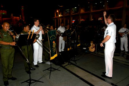 US Navy 040625-N-4104L-030 Musician 1st Class Alex Gowland conducts the Seventh Fleet band
