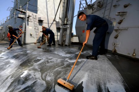 US Navy 111004-N-YZ751-114 Sailors scrub the deck aboard the guided-missile destroyer USS Truxtun (DDG 103) photo