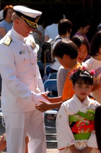 US Navy 040514-N-1194D-015 Commander Seventh Fleet, Vice Adm. Robert F. Willard, shakes hands with a Japanese boy at Gyokusenji Temple