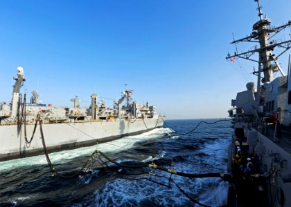 US Navy 111213-N-VH839-041 The Military Sealift Command fast combat support ship USNS Rainier (T-AOE 7) transits alongside the Arleigh Burke-class