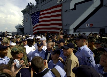 US Navy 040604-F-6655M-255 U.S. Secretary of Defense Donald Rumsfeld poses for pictures with Sailors and Marines on the flight deck aboard the amphibious assault ship USS Essex (LHD 2)