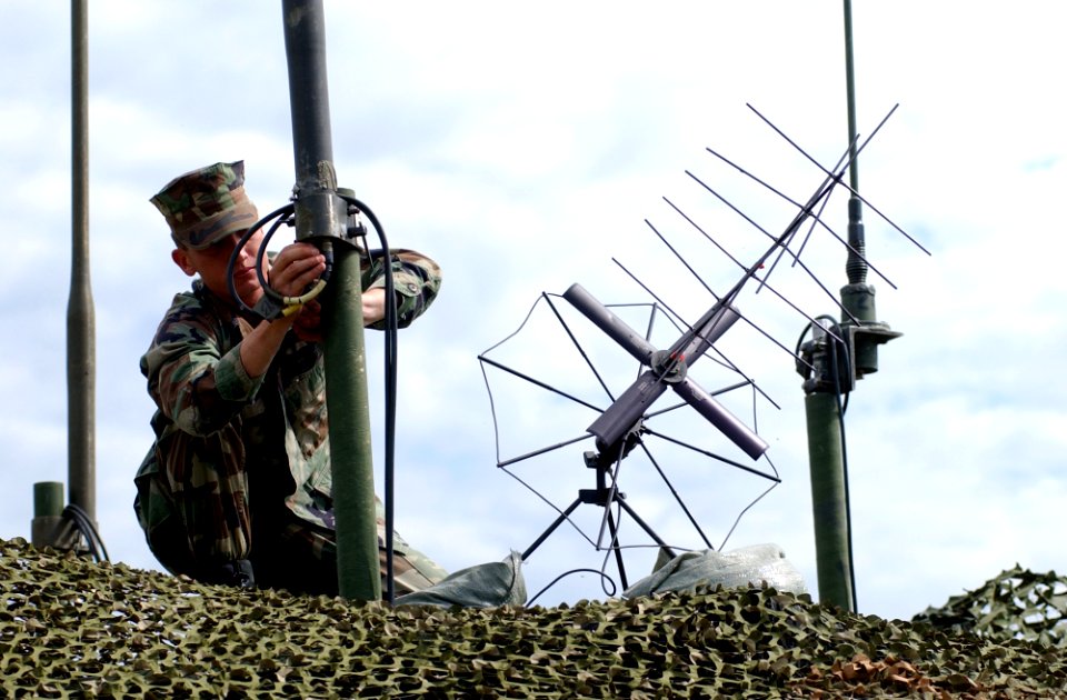 US Navy 040607-N-8252B-078 Ground Aviation Radio Repairman Lance Cpl. Russel I. Holmes from St. Helena, Calif., checks the wiring on the VHF AS 3900 antenna
