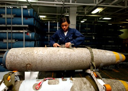 US Navy 040429-N-1082Z-116 Aviation Ordnanceman Airman Lauren Carr, from Atlanta, Ga., puts a switch on a 2,000 lbs MK-84 general-purpose bomb