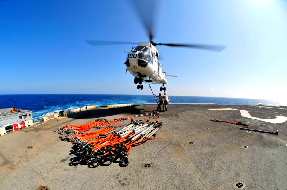 US Navy 111027-N-KM175-093 Cpl. Todd Green, left, and Pfc. Kevin Adams attach pallet rigs to an SA-330J Puma helicopter abord the forward-deployed