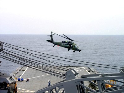 US Navy 040624-N-4104L-008 A Royal Brunei Sikorsky S-70 Battle Hawk helicopter takes off from the flight deck of the amphibious dock landing ship USS Fort McHenry (LSD 43)