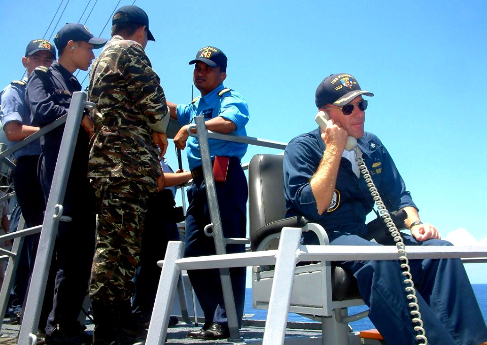 US Navy 040527-N-4104L-001 Guided missile destroyer USS Russell (DDG 59), Commanding Officer, Cmdr. William Kearns III, communicates with his combat information center