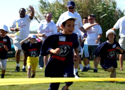 US Navy 040603-N-0780F-035 A student from the Therapeutic and Rehabilitation Center for Children and Youth School in Chania, Crete nears the finish line in a race