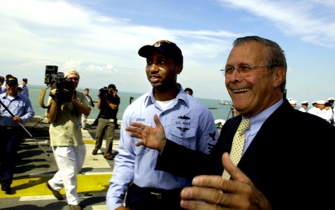 US Navy 040604-F-6655M-102 U.S. Secretary of Defense Donald Rumsfeld meets with Sailors and Marines on the flight deck aboard the amphibious assault ship USS Essex (LHD 2)