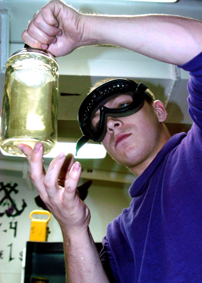 US Navy 040626-N-2972R-055 Airman Adam Deil, of Rochester, N.Y., tests a JP-5 fuel sample aboard the amphibious assault ship USS Kearsarge (LHD 3)