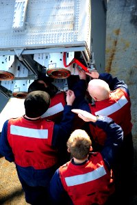 US Navy 111129-N-QL471-261 Sailors unload a NATO Sea Sparrow missile from a launcher aboard the aircraft carrier USS George H.W. Bush