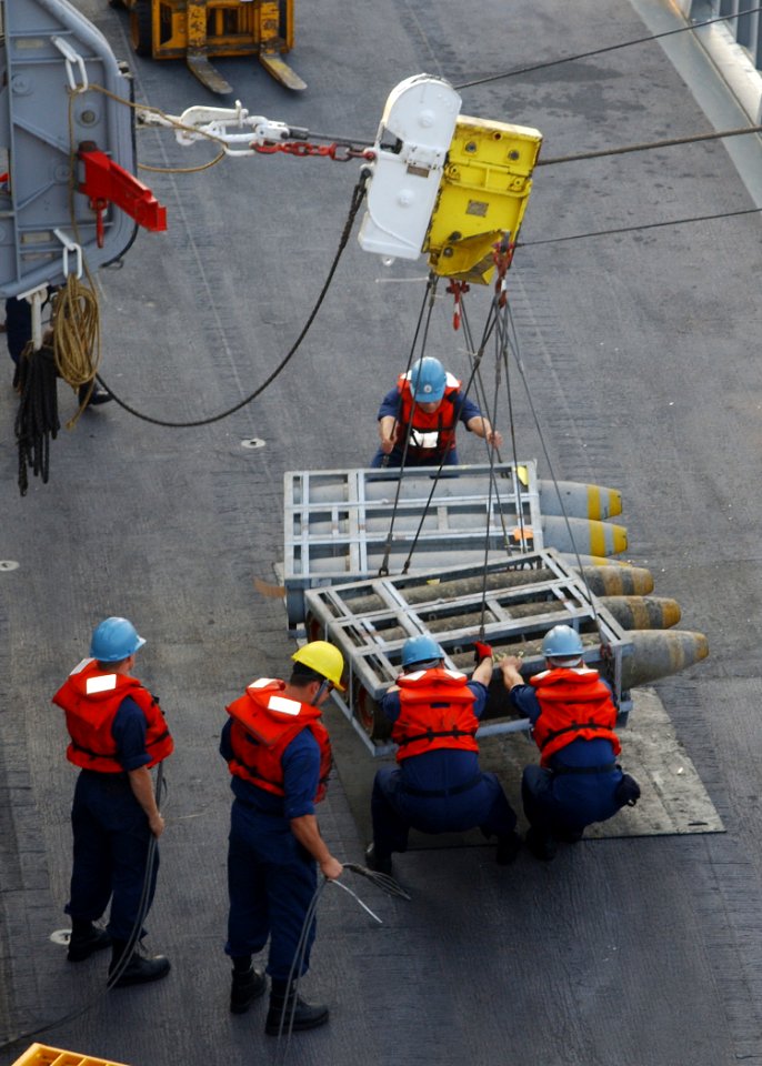 US Navy 040607-N-4374S-017 Sailors assigned to the fast combat support ship USS Seattle (AOE 3) conduct ammunition on load during a underway replenishment with the ammunition ship USNS Mount Baker (T-AE 34)