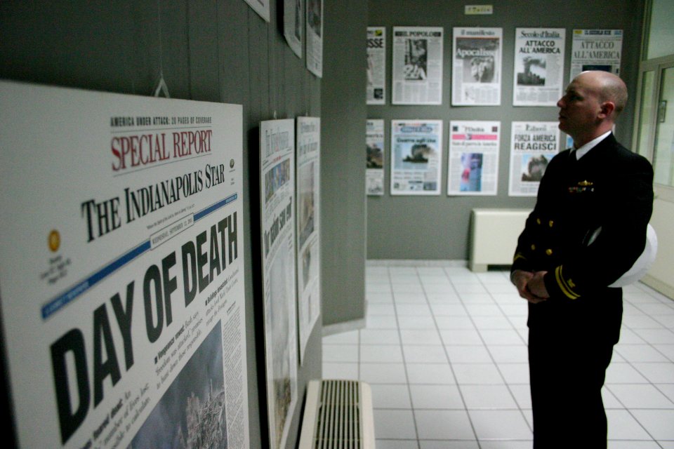 US Navy 040325-N-5821W-002 Lt. j.g. Chris Newell looks over copies of the front pages of newspapers featuring the events occurring on Sept. 11, 2001