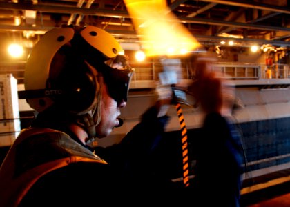 US Navy 040609-N-2972R-127 Boatswains Mate 3rd Class Josh Rogers, from Versailes, Ky., directs a Landing Craft, Air Cushion (LCAC) photo