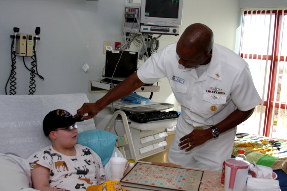 US Navy 111025-N-NT881-021 Command Master Chief of the amphibious transport dock ship USS San Antonio (LPD 17), Master Chief Michael Hart places a