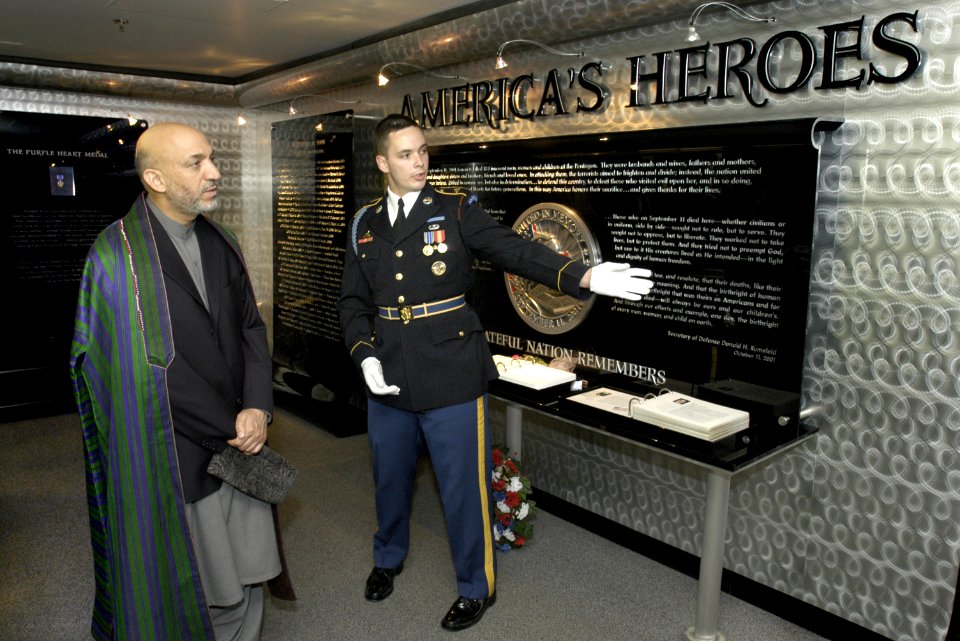 US Navy 040614-D-9880W-109 President of Afghanistan's Transitional Government Hamid Karzai listens as a U.S. Army Honor Guard tell him about the Pentagon memorial and the 184 persons killed in the terrorist attack