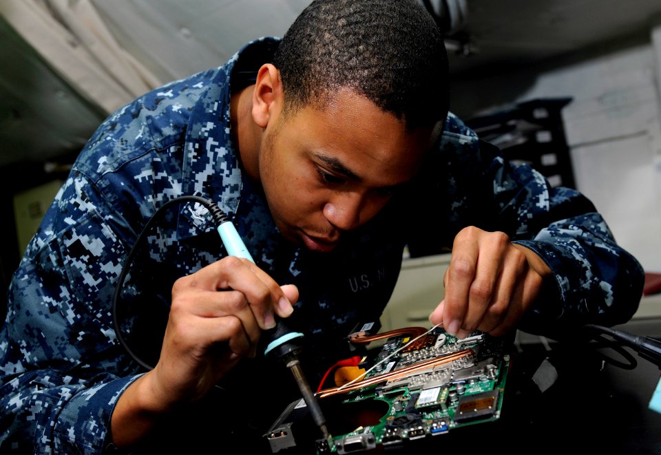 US Navy 120110-N-RG587-008 Interior Communications Electrician 3rd Class Rowdy Rasmus solders visual landing aid (VLA) computer equipment