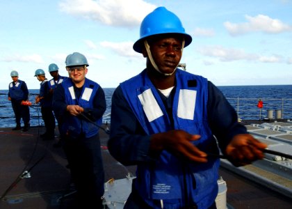 US Navy 040616-N-4374S-011 Sailors assigned to the guided missile cruiser USS Vicksburg (CG 69) heave on the phone and distance line during an underway replenishment with the fast combat support ship USS Seattle (AOE 3)