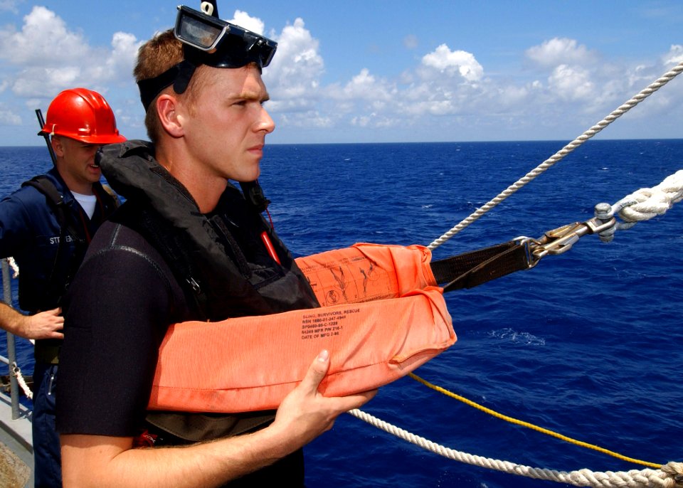 US Navy 040610-N-4374S-004 Gunner's Mate 3rd Class David Renner, a Search and Rescue (SAR) swimmer assigned to the fast combat support ship USS Seattle (AOE 3), stands ready to be lowered into the water