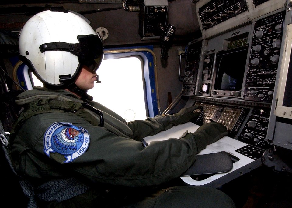 US Navy 040619-N-4374S-006 Aviation Warfare Systems Operator 3rd Class Jonathan Gardner tracks a surface contact aboard an SH-60B Seahawk helicopter during a training flight over the Atlantic Ocean