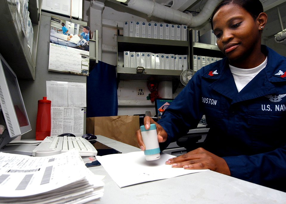 US Navy 040331-N-6278K-010 Storekeeper 1st Class Ketina Houston, of St. Marys, Ga., validates supply receipts in S-10 Division's Quality Assurance office aboard USS George Washington (CVN 73)