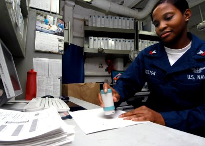 US Navy 040331-N-6278K-010 Storekeeper 1st Class Ketina Houston, of St. Marys, Ga., validates supply receipts in S-10 Division's Quality Assurance office aboard USS George Washington (CVN 73)