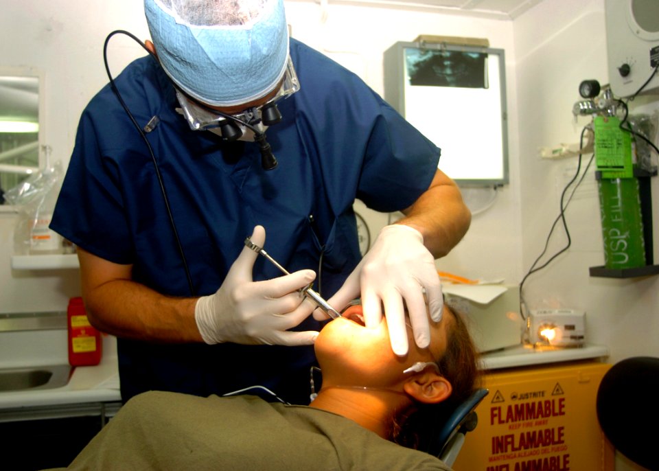 US Navy 040616-N-2613R-006 11th Marine Expeditionary Unit (MEU) Dentist. U.S. Navy Lt. Brain Olsen, a native of Christ, Utah, injects Novocain into a service members mouth