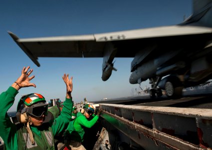 US Navy 120206-N-DR144-738 Deck edge catapult operator Aviation Boatswain's Mate (Equipment) 2nd Class Blas Manzanares launches an f-A-18 Hornet