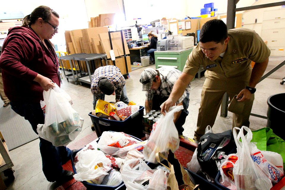 US Navy 111123-N-HW977-185 Sailors weigh Thanksgiving food drive donations before delivery to the Corona-Norco Settlement House