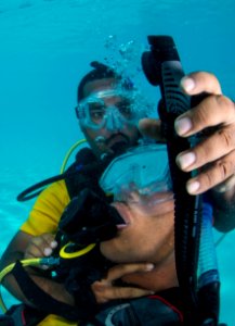US Navy divers and Belizean Coast Guard divers practice SCUBA emergency procedures in a pool 140624-N-IP743-311