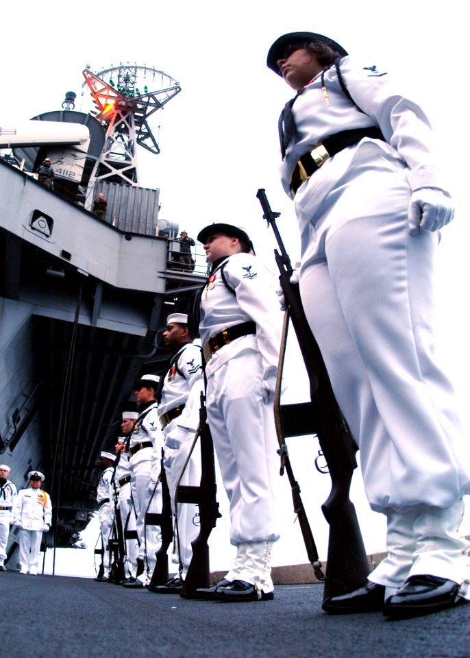US Navy 040620-N-9446C-051 Ceremonial Guard Members assigned to the Nimitz-class aircraft carrier USS Carl Vinson (CVN 70) stand at attention during a burial at sea ceremony held on one of the ship's four deck edge aircraft elevators