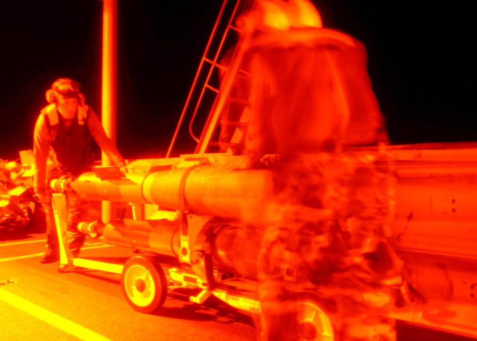 US Navy 040715-N-8704K-003 Aviation Ordnancemen move a skid of laser guided bombs on the flight deck aboard USS John F. Kennedy (CV 67)