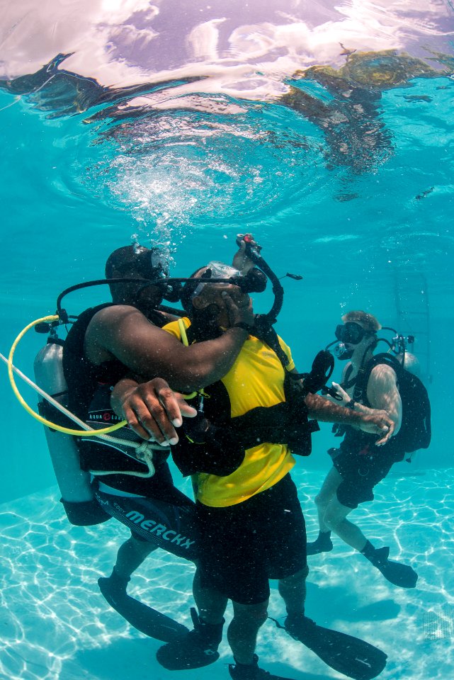 US Navy divers and Belizean coast guard divers practice SCUBA emergency procedures in a pool 140625-N-IP743-220