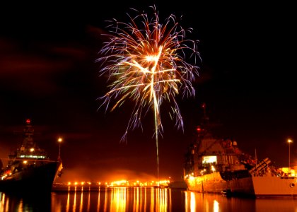 US Navy 040704-N-3019M-002 Fireworks explode over the guided missile cruiser USS Champlain (CG 57) and Republic of South Korean destroyers Yi (DDH 975) and Ulchimoonduk (DDH 972) photo