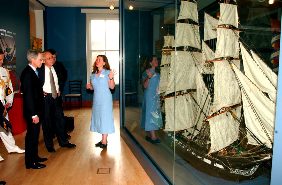 US Navy 040625-N-2568S-006 Curator for the USS Constitution Museum, Sarah Watkins, describes the Constitution's rigging to Secretary of the Navy, Gordon R. England and British Ambassador, Sir David Manning during a tour of the