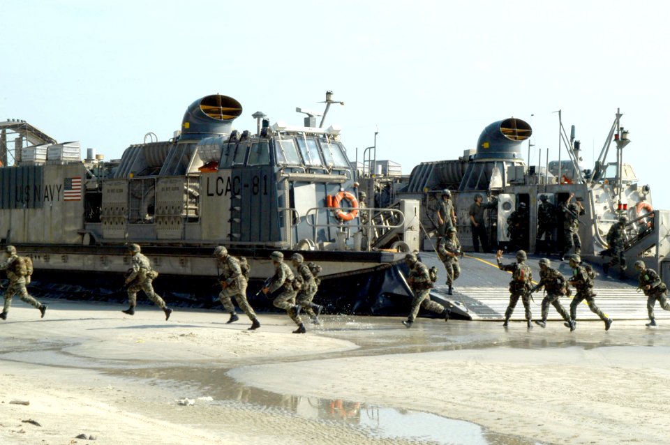 US Navy 040720-N-4104L-030 Landing force members of the Royal Malay Regiment (RMR) hit the beach running from a U.S. Navy Landing Craft Air Cushioned (LCAC)