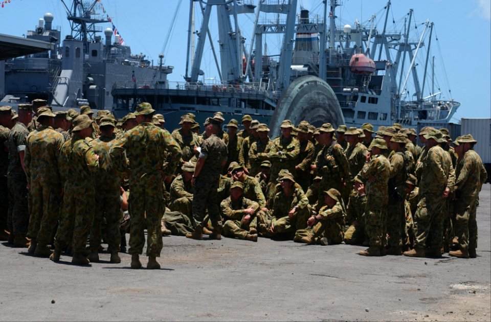 US Navy 040705-N-6551H-112 Combat Cargo Assistant, Gunnery Sgt. Lee Griffey, briefs soldiers from the Royal Australian Army's Charlie Company about how life aboard the ship