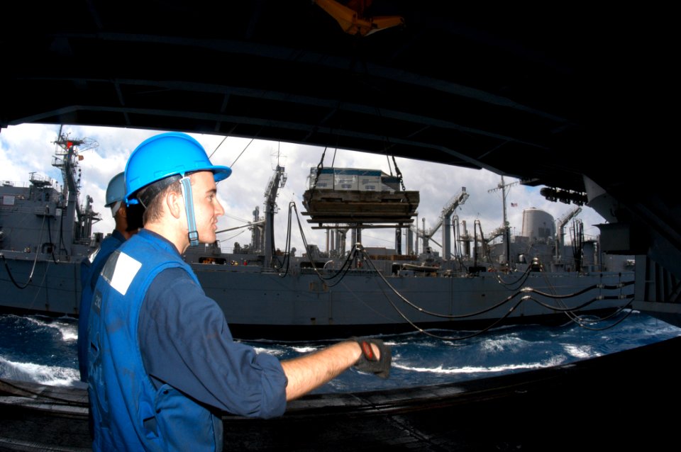 US Navy 040619-N-8704K-006 While conducting an underway replenishment, Boatswain's Mates aboard USS John F. Kennedy (CV 67) prepare to steady a load of cargo from fast combat support ship USS Seattle (AOE 3)
