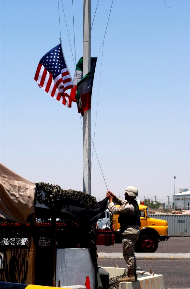 US Navy 040629-C-1034C-026 Petty Officer 1st Class Jeffrey Dusenberry, a Port Security Specialist assigned to U.S. Coast Guard Port Security Unit Three Zero Seven (PSU- 307), changes the temperature flag