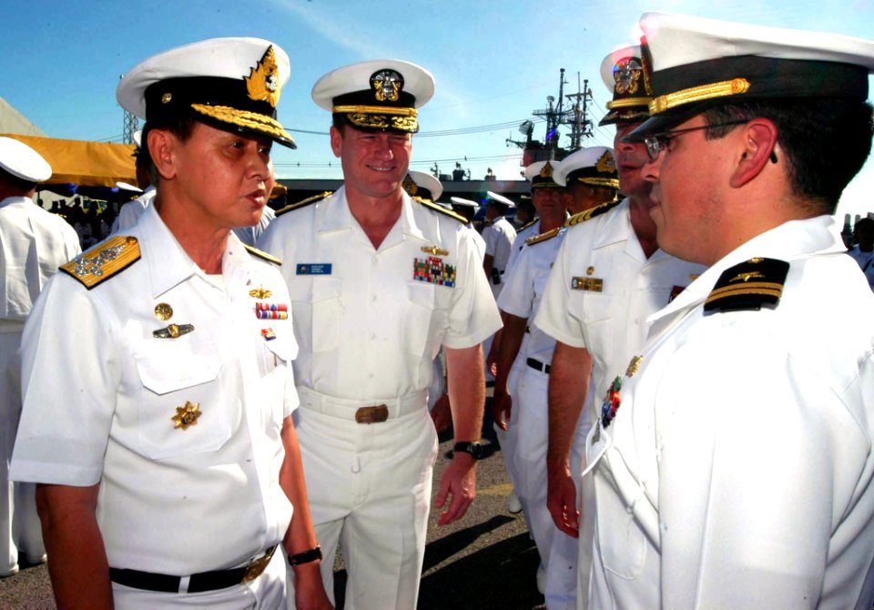 US Navy 040630-N-4104L-010 Commander-in-Chief of the Royal Thai Fleet, Adm. Vichai Yuwanangoon speaks with COMDESRON One's Operations Officer Lt. Miguel Iniguez, during an inspection of troops that concluded the opening ceremon
