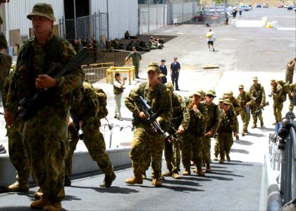 US Navy 040705-N-6551H-048 Soldiers assigned to Charlie Company, Royal Australian Army embark the amphibious assault ship USS Tarawa (LHA 1)
