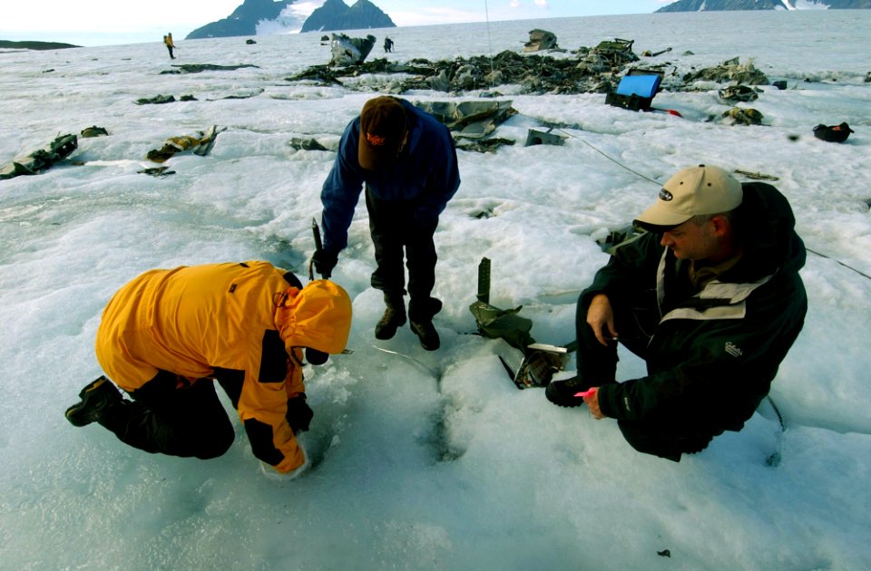US Navy 040808-N-0331L-001 Hospital Corpsman 2nd Class Clay Cowley searches the wreckage of a Navy P-2V Neptune aircraft that crashed over Greenland in 1962