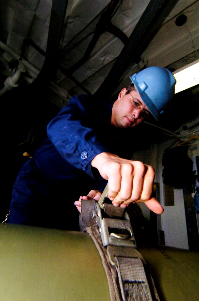 US Navy 040714-N-1464F-004 Gunner's Mate 1st Class Dennis Wolf Chicago, Ill., straps a MK 46 recoverable exercise torpedo into a dolly aboard the guided missile frigate USS Crommelin (FFG 37) during UNITAS 45-04