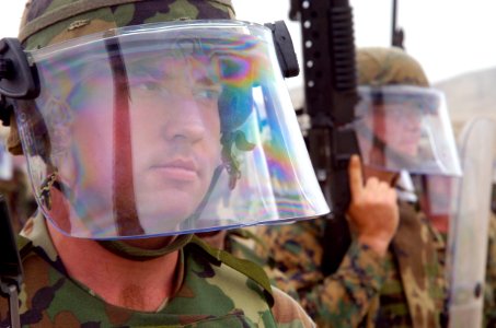 US Navy 040707-N-1464F-009 Marine Cpl. Eric Harper, from 2 MACE out of Camp LeJeune, stands riot control during a training exercise