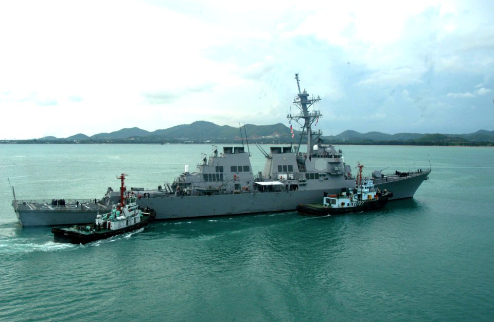 US Navy 040708-N-4104L-031 The guided missile destroyer USS Russell (DDG 59), is assisted by two tugboats as it returns to port following the Thailand phase of exercise Cooperation Afloat Readiness and Training (CARAT)