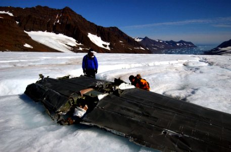 US Navy 040809-N-0331L-006 Lt. Cmdr. Christopher Blow, left, and Lt. Cmdr. Steve Dial examine the wreckage of a Navy P-2V Neptune aircraft that crashed over Greenland in 1962