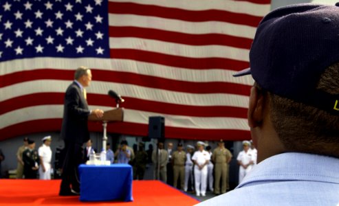 US Navy 040604-F-6655M-092 Sailors and Marines aboard the amphibious assault ship USS Essex (LHD 2) assemble on the ship's flight deck for an address by the U.S. Secretary of Defense Donald Rumsfeld