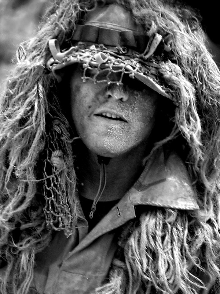 US Navy 040717-F-6340W-319 A U.S. Navy SEAL (Sea, Air, Land) conceals himself under camouflage during a demonstration of seizing a beach