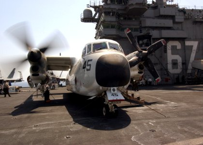 US Navy 040709-N-4374S-014 A C-2 Greyhound assigned to Rawhides of Fleet Logistics Support Squadron Four Zero (VRC-40) performs a start-up procedure on a starboard engine on the flight deck aboard USS John F. Kennedy (CV 67)