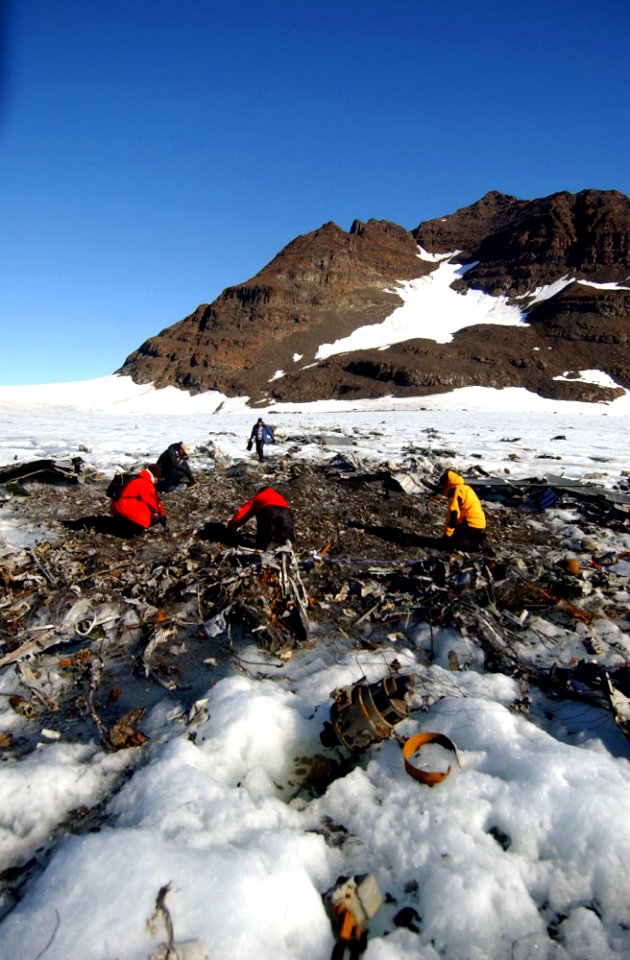 US Navy 040811-N-0331L-005 Recovery personnel examine the wreckage of a Navy P-2V Neptune aircraft that crashed over Greenland in 1962