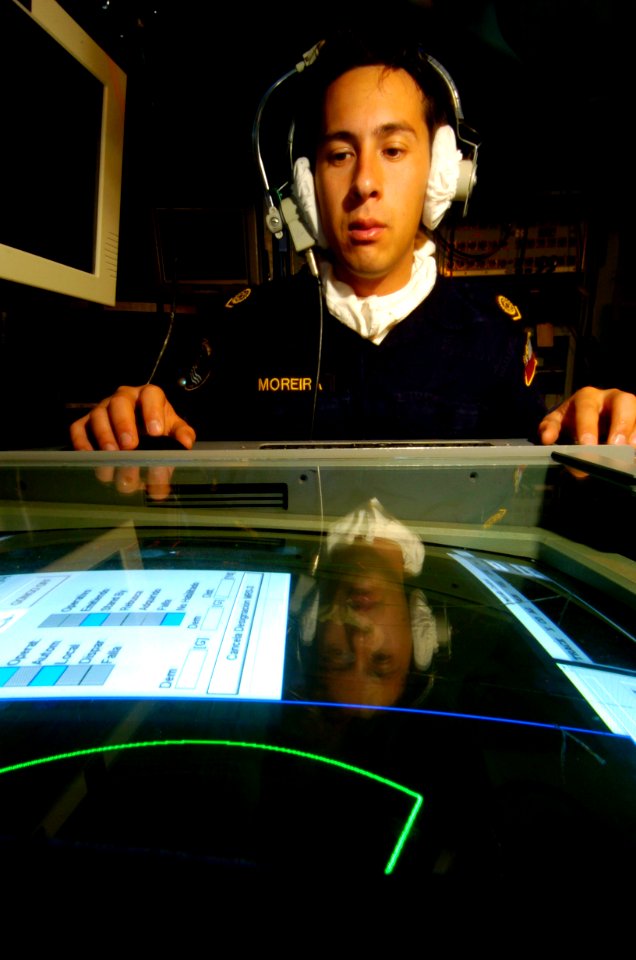 US Navy 040712-N-1464F-004 Chilean Electronics Technician Walter Moreira Miranda operates the command and control system console in the Combat Information Center aboard the Chilean gunnery patrol frigate Ministro Zenteno (FFG 8